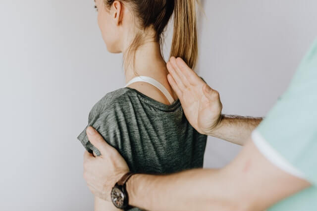 Bones for Life practitioner demonstrating alignment on woman's back